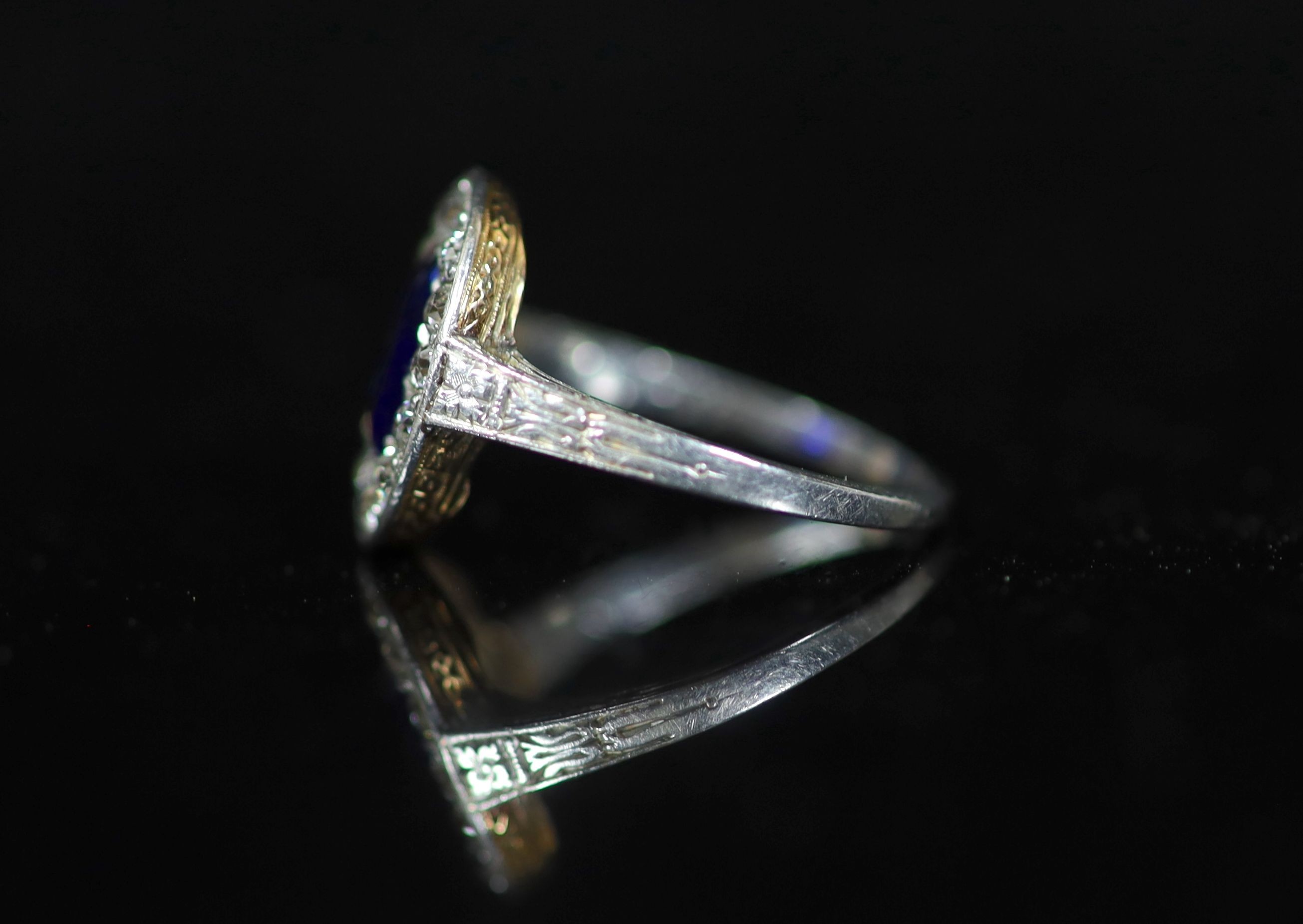A 1930's platinum and gold, sapphire and diamond set oval cluster ring